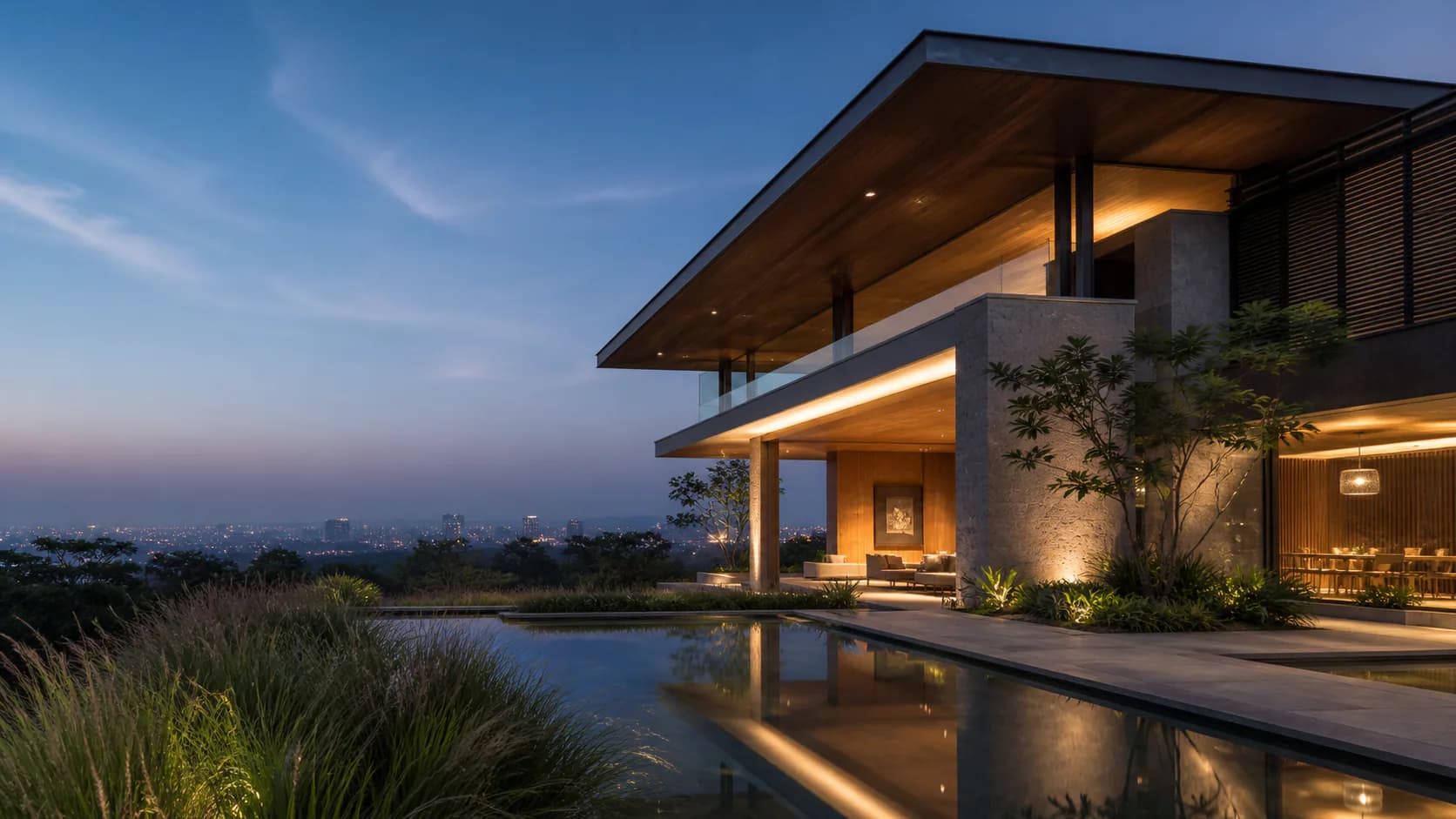 Contemporary stone residence overlooking a landscaped reflecting pool at dusk